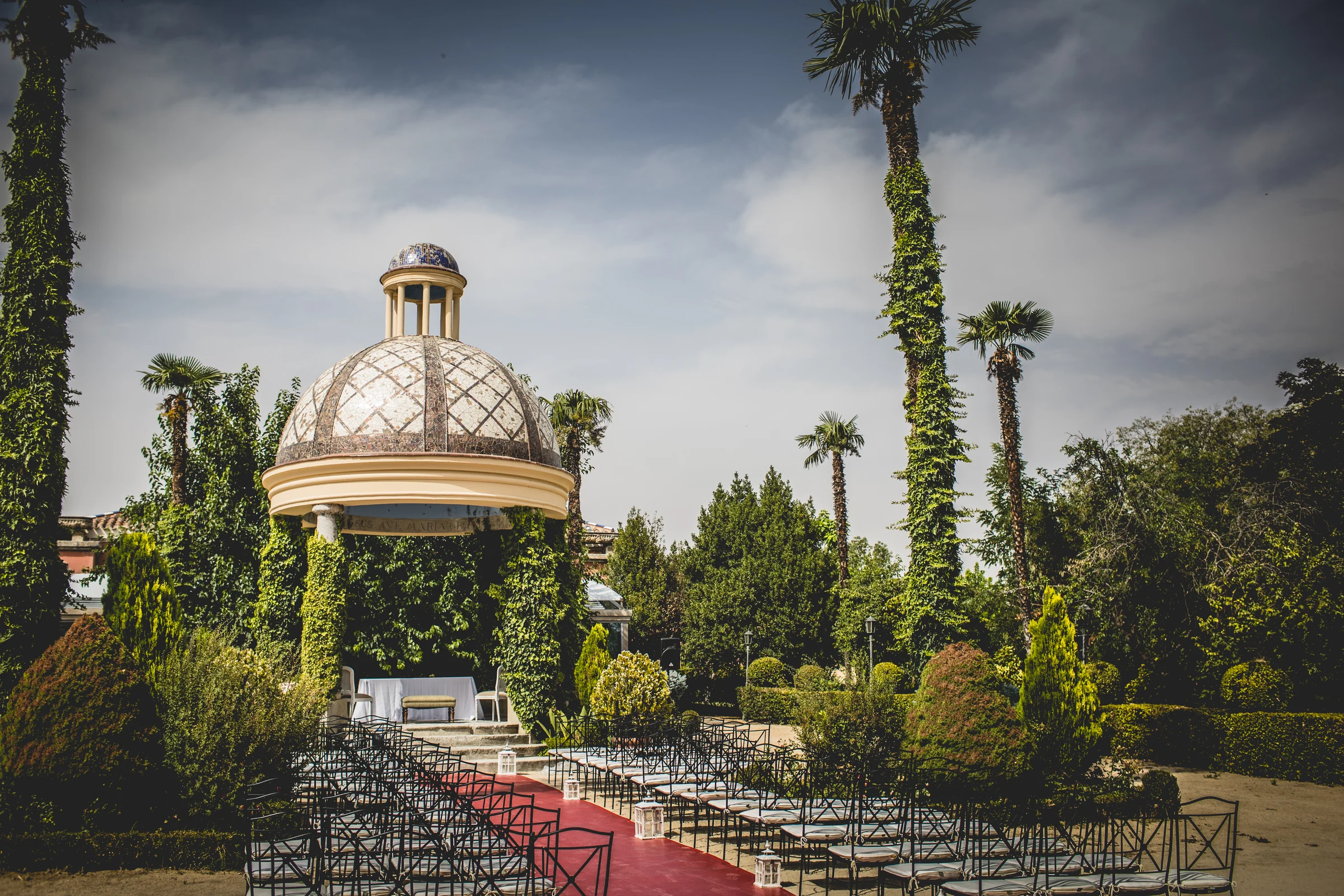 Templete acristalado entre los jardines de la finca, fotografía de boda en el Castillo de Viñuelas.
