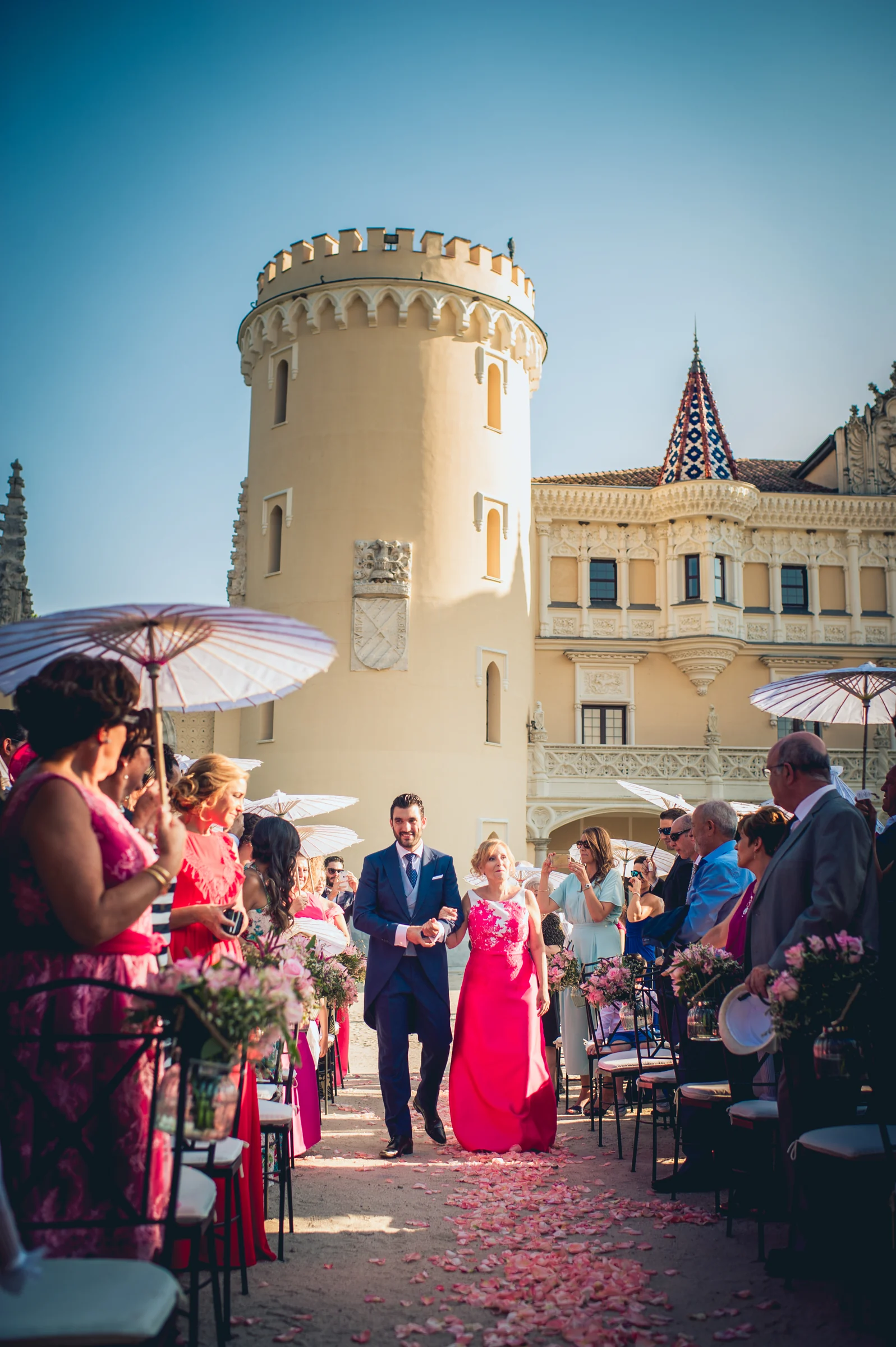 Entrada de la novia a la ceremonia junto a un acompañante, fotografía de boda en el Castillo de Viñuelas.