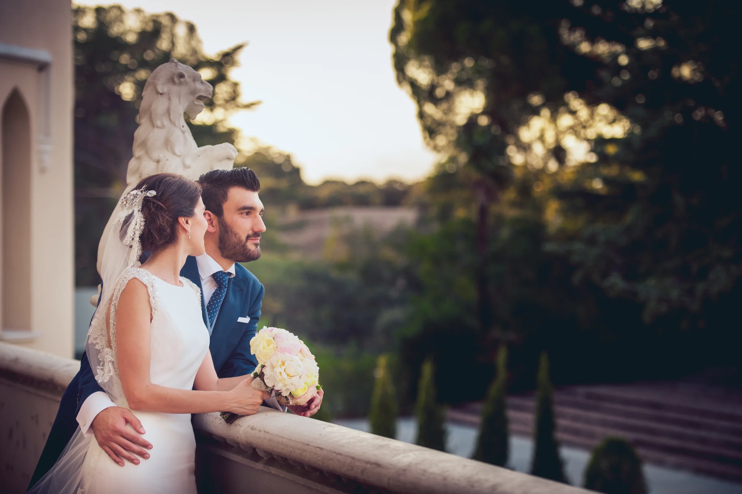 Novios apoyados en una balaustrada del castillo, fotografía de boda en el Castillo de Viñuelas.