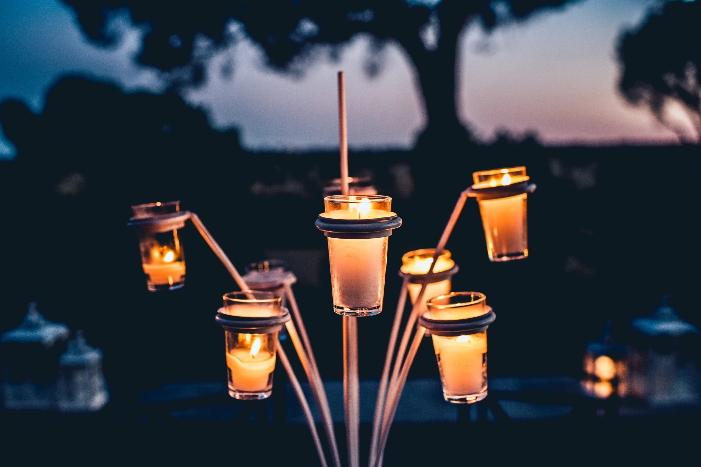 Velas exteriores encendidas al anochecer, fotografía de boda en el Castillo de Viñuelas.