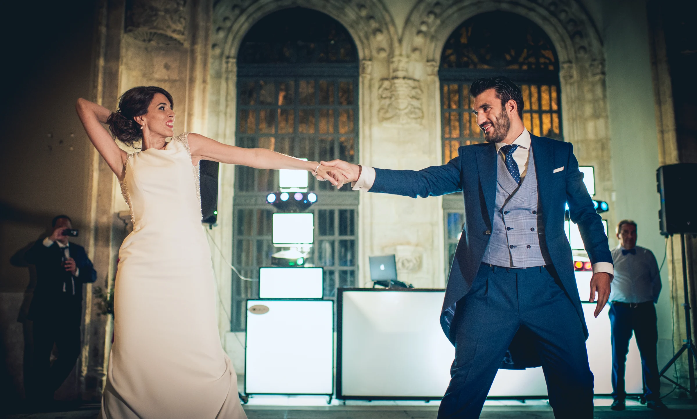 Novios bailando frente al equipo de música, fotografía de boda en el Castillo de Viñuelas.