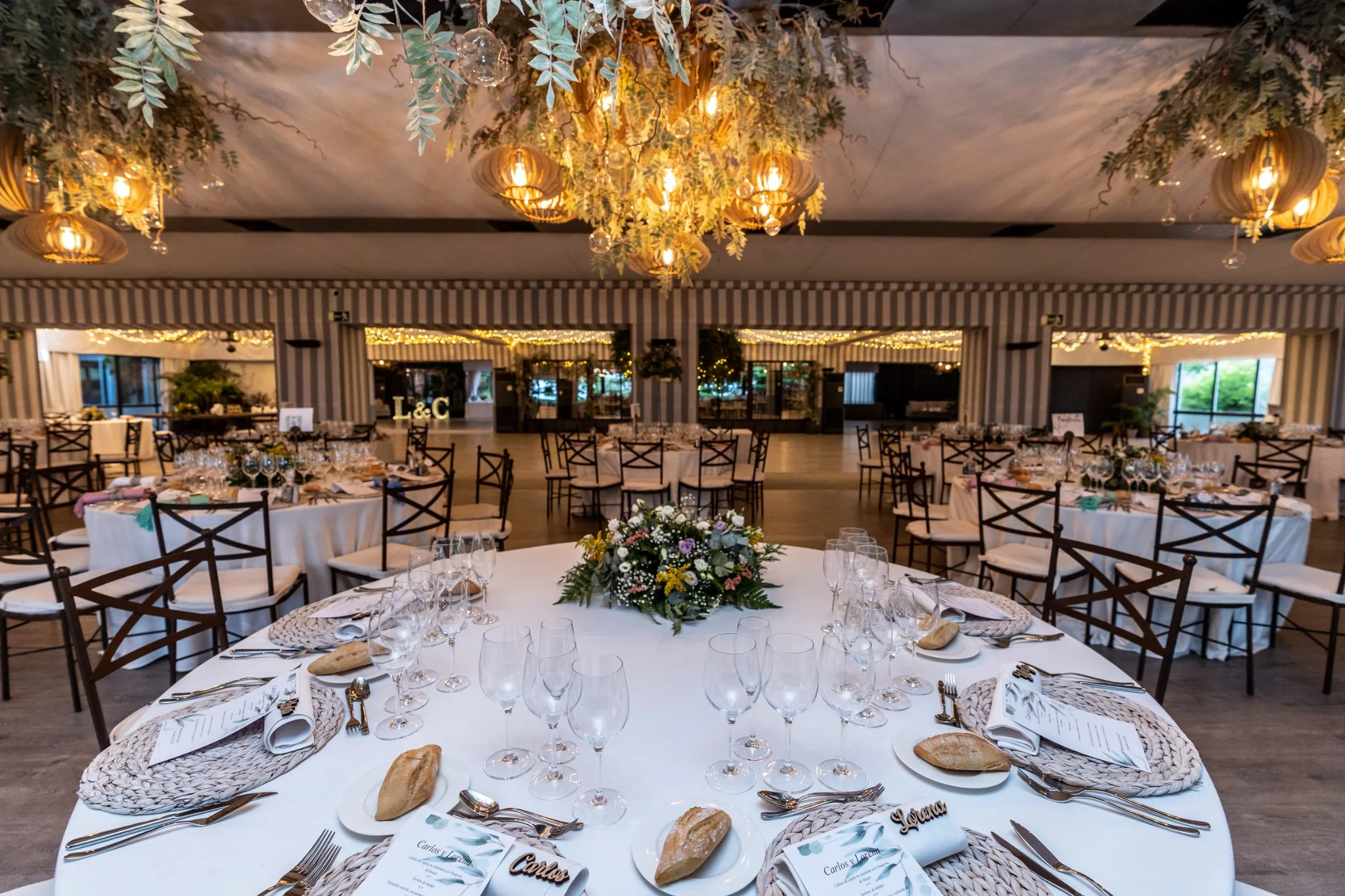 Mesa de banquete decorada con vajilla y centros florales en una boda en Peñarrubia de Araceli, fotografía de Pedro Zamorano.