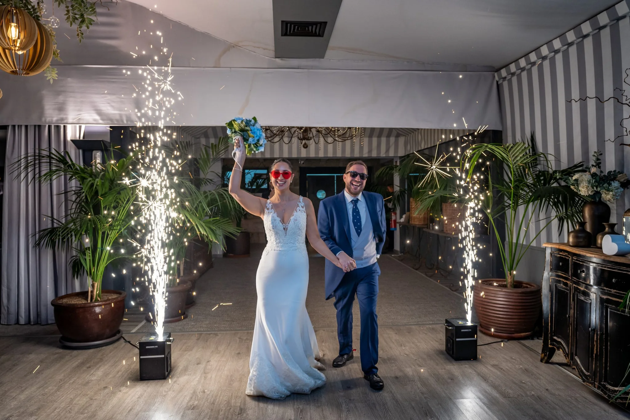 Entrada de los novios al salón entre bengalas en una boda en Peñarrubia de Araceli, fotografía de Pedro Zamorano.