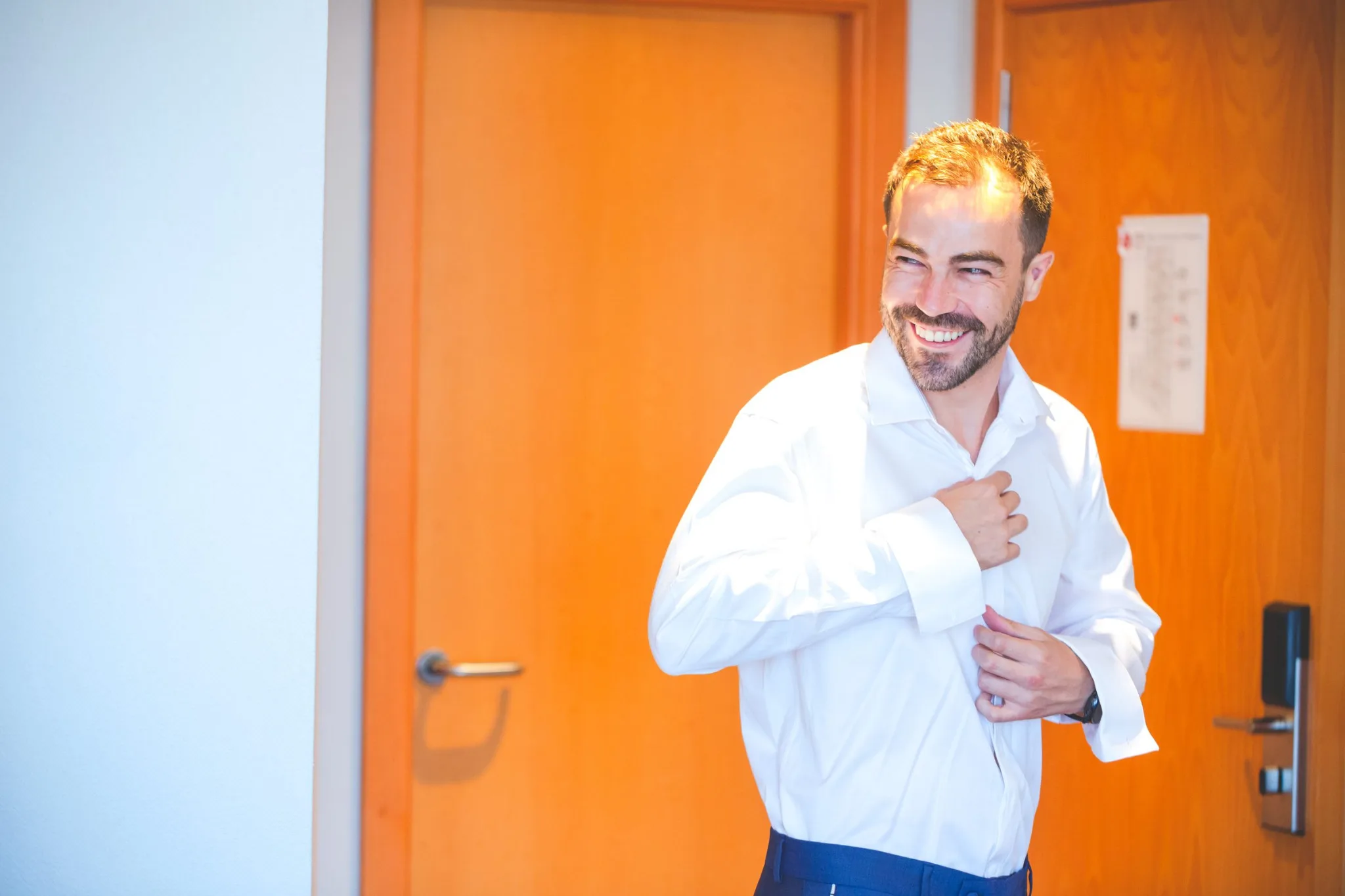 Novio abrochandose la camisa durante una boda en Valquijancho.