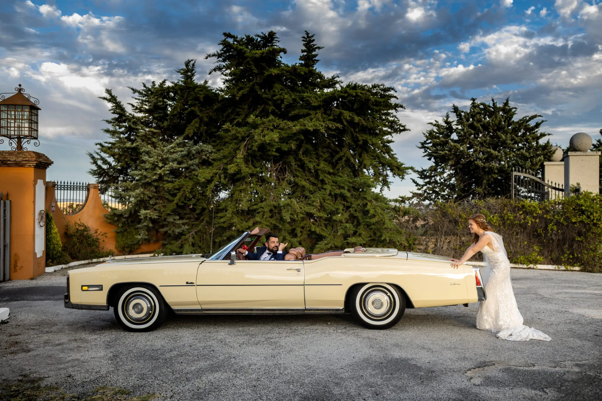 Novios junto al coche clasico en la entrada durante una boda en Valquijancho.