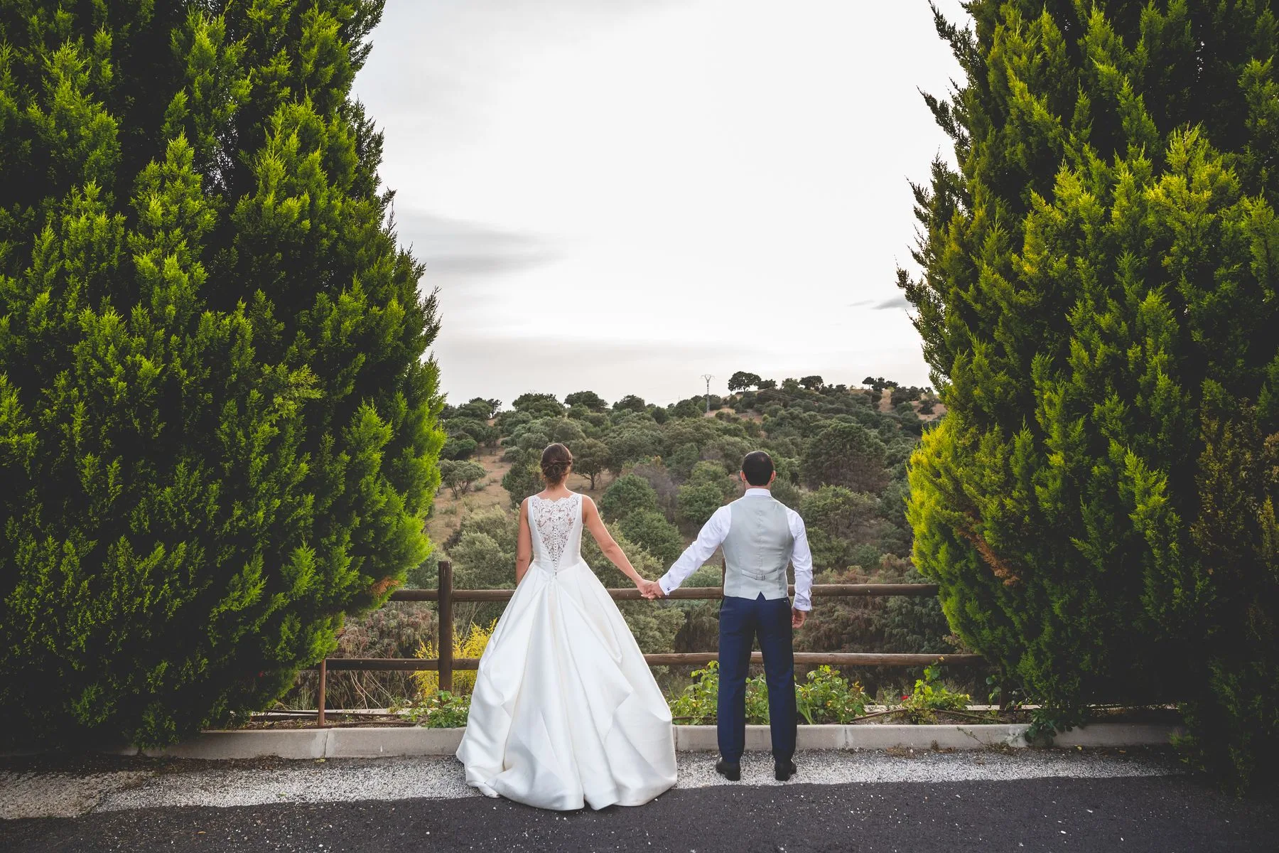 Novios paseando entre cipreses durante una boda en Valquijancho.